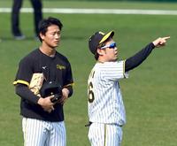 　初めての甲子園練習で西勇（右）からアドバイスを受ける森木（撮影・山口登）