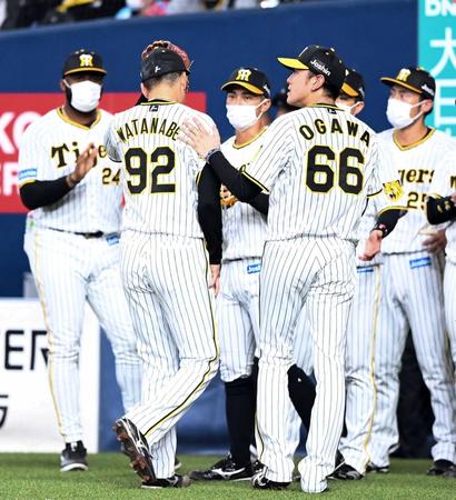 　６回、ベンチに戻る渡辺を迎える小川（撮影・飯室逸平）