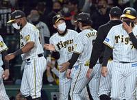 久々の勝利にほっとした表情でナインを迎える矢野監督（中央）＝撮影・田中太一