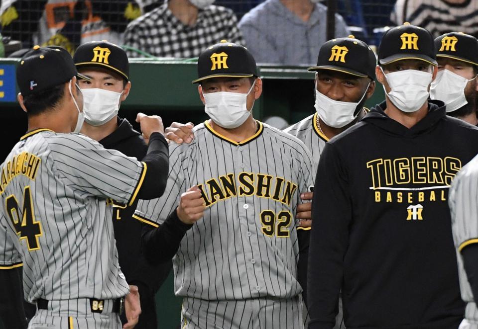 プロ初勝利を挙げ、原口（左手前）、ロハス（右奥）から祝福される渡辺（中）＝撮影・佐藤厚