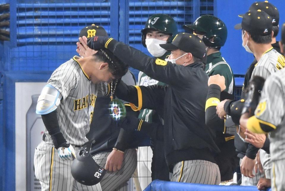 ５回、右越えにソロを放ち矢野監督からメダルをかけられる糸原（撮影・佐々木彰尚）