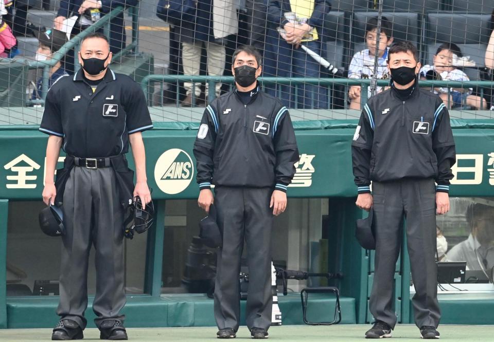 国歌斉唱で整列する白井塁審（中央）ら＝甲子園（撮影・飯室逸平）