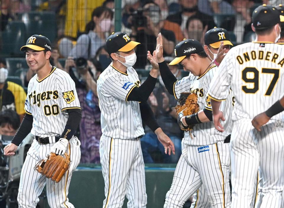 　大山と勝利のハイタッチをかわす矢野監督（撮影・飯室逸平）