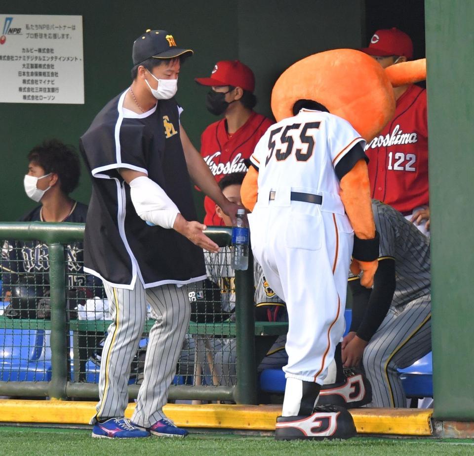 　４回、グラウンドからの退場が遅れ、試合を止めたジャビット（中央）を三塁ベンチ内へ誘導する阪神・森木（左）＝（撮影・吉澤敬太