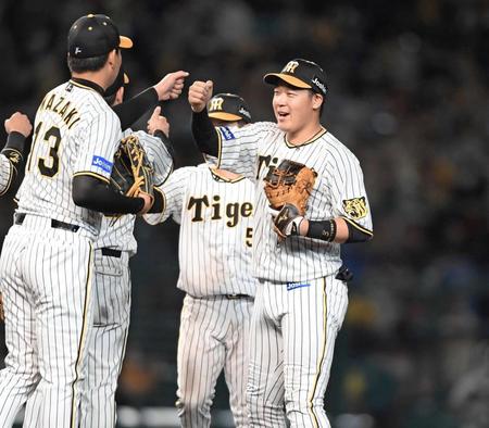 　５割復帰となり、最後を締めた岩崎（左）と勝利のタッチを交わす大山（撮影・田中太一）