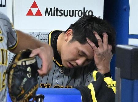 　７回途中降板し、ベンチで頭を抱える才木（撮影・堀内翔）