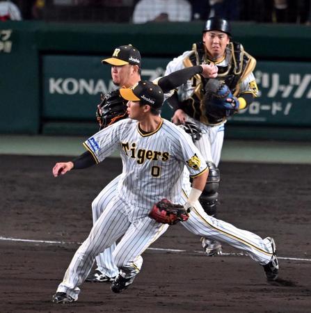 　１１回、岩貞は小園の犠打を捕球し一塁へ悪送球する（撮影・山口登）