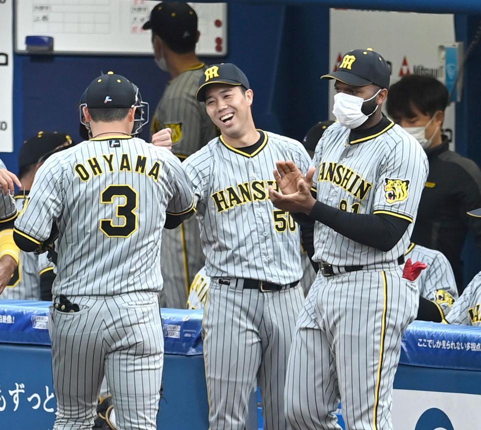 　６回、大山らナインを笑顔で迎える青柳（撮影・飯室逸平）