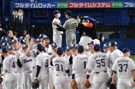 　高津監督に声をかける矢野監督（撮影・佐々木彰尚）