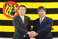 握手を交わす百北幸司球団社長（左）と嶋田宗彦１軍バッテリーコーチ（代表撮影）