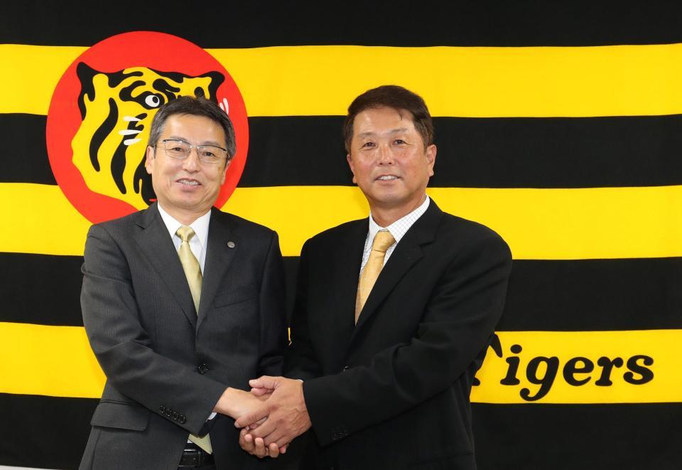 握手を交わす百北幸司球団社長（左）と水口１軍打撃コーチ（代表撮影）