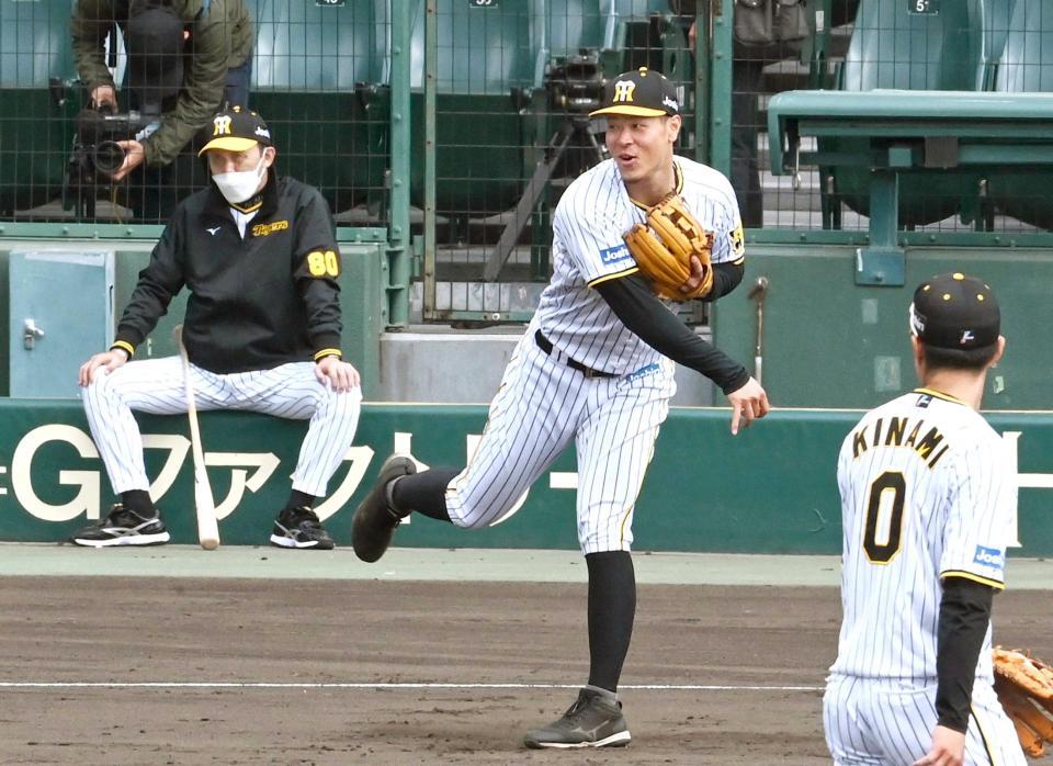 　岡田監督が見守る中、三塁で守備練習する佐藤輝（撮影・飯室逸平）