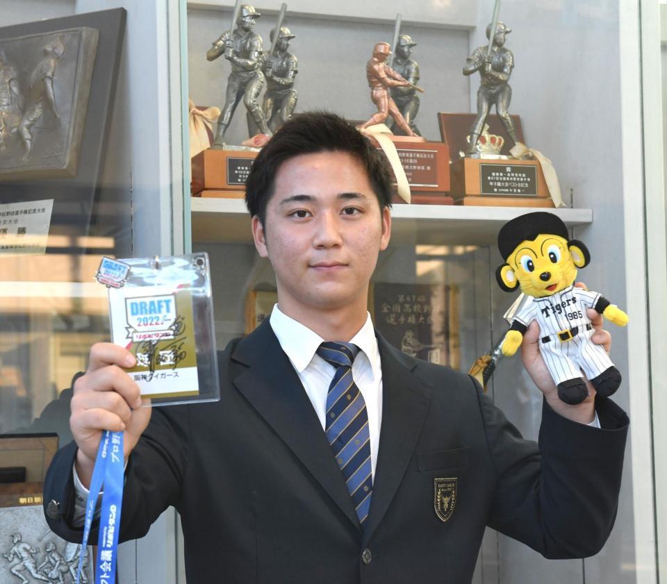 　岡田監督のサインが入ったドラフト会議の通行証を手にする阪神ドラ３の井坪陽生（撮影・佐々木彰尚）