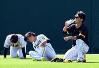 　伊藤将（右）は走り込みをし水分補給をする（撮影・山口登）