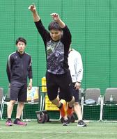 　立ち幅跳びで跳躍する井坪