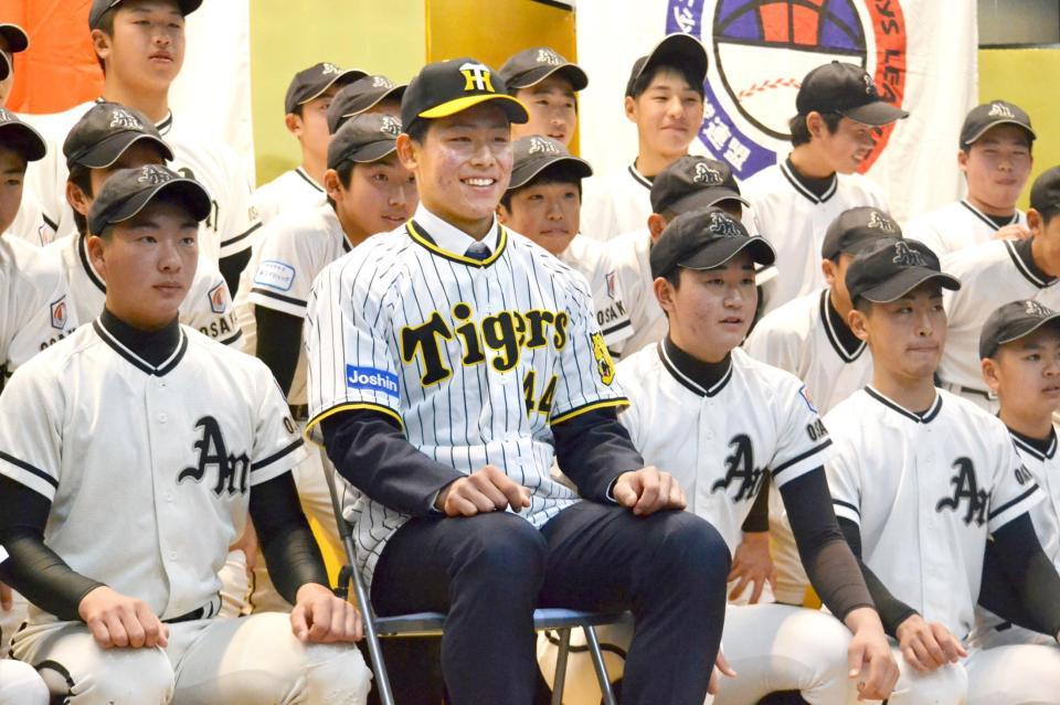 　松原ボーイズの選手たちと笑顔で記念撮影する戸井