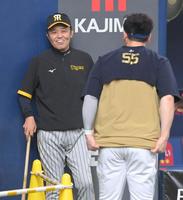 　試合前、Ｔ－岡田（手前）からあいさつされる岡田監督（撮影・高部洋祐）