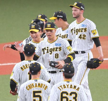 　オリックスに勝利しナインとタッチを交わす佐藤輝（中央）＝撮影・立川洋一郎