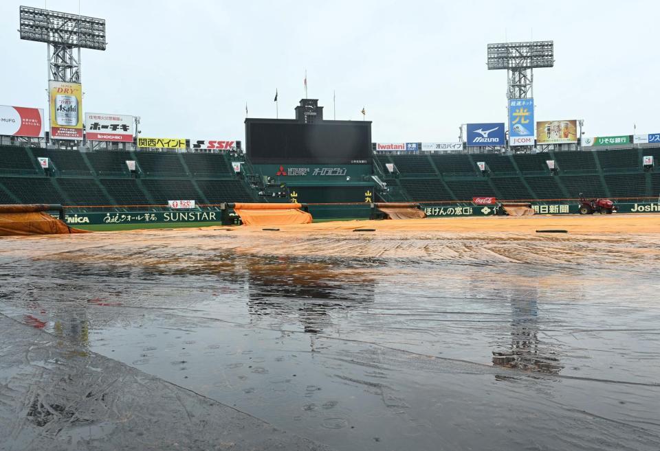 　雨水がグランドに溜まった甲子園球場（撮影・飯室逸平）