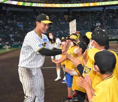 　ファンクラブの子どもたちとハイタッチを交わす木浪（左）＝撮影・北村雅宏