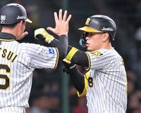 ４回、ソロを放って生還し迎える筒井コーチ（左）と拳でタッチを交わす佐藤輝（撮影・立川洋一郎）