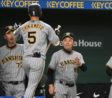 　１回、先頭打者本塁打を放った近本（左）を迎える岡田監督（撮影・堀内翔）