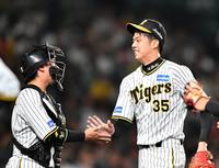 　７回を投げ終え、梅野（左）とタッチを交わす才木（撮影・中田匡峻）