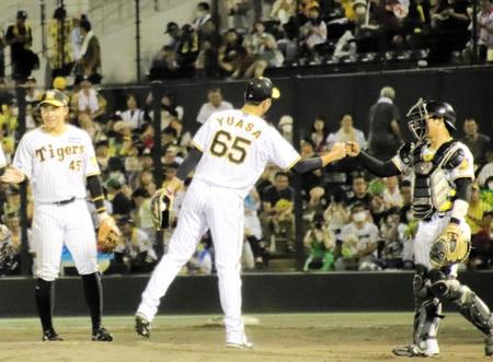 　九回に登板し試合を締めて中川とグータッチを交わす湯浅