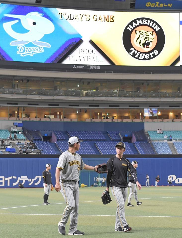 　軽めのキャッチボールを終え、グラウンドから引き揚げる近本（右）＝撮影・高部洋祐