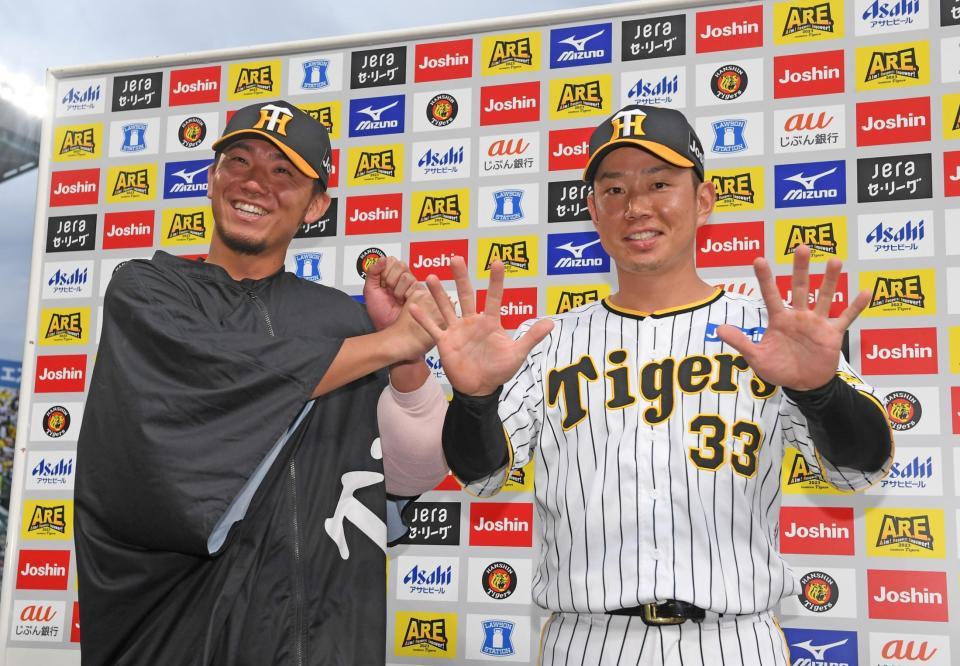 　お立ち台でお互いを祝福する伊藤将（左）と糸原（撮影・中田匡峻）