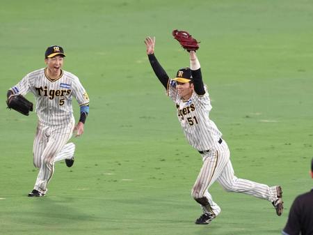 　ウイニングボールを捕球し喜ぶ中野（右）と近本（撮影・山口登） 