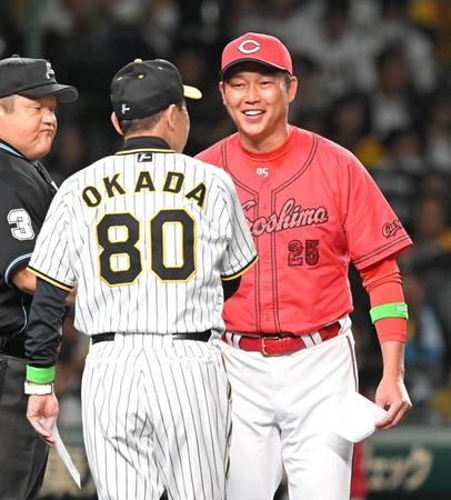 　試合前、岡田監督（80）とメンバー表交換をする新井監督（撮影・高部洋祐）