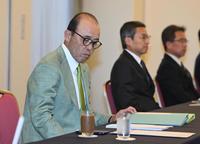 　資料に目を通す岡田監督（撮影・金田祐二）