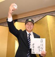 　得意球カーブの握りを見せながら、色紙に意気込みを記した大経大・津田（撮影・中田匡峻）