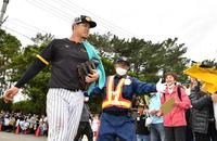 　特守を終えた佐藤輝（左）は多くの歓声を受け、ガードマンに守られながら引き揚げる（撮影・中田匡峻）