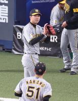 　３回、西川の二直を処理した中野（５１）をグラブをたたきながら迎える才木（撮影・中田匡峻）