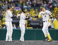 　６回、３ランを放った佐藤輝は生還した森下（左端）、中野（中央）とタッチをかわす（撮影・石井剣太郎）