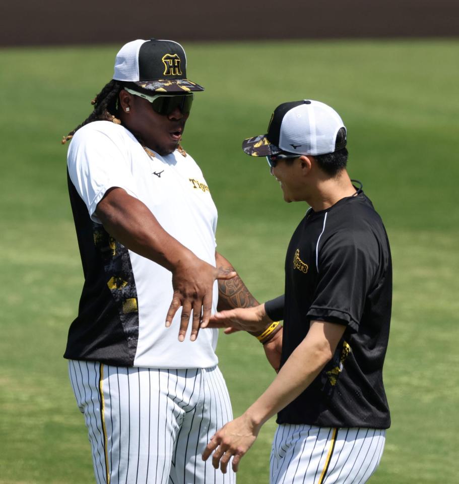 　１軍に合流し、木浪（右）とタッチを交わすミエセス（撮影・中田匡峻）