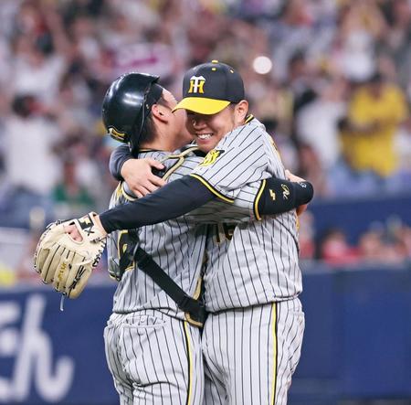 　完封勝利を飾り、梅野（左）と抱き合って喜ぶ西勇（撮影・立川洋一郎）