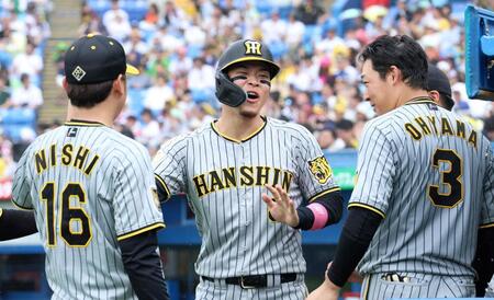 　６回、梅野の適時打で生還した佐藤輝は大山（右）、西勇（左）に迎えられる（撮影・田中太一）