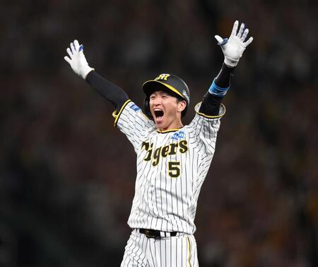 　９回、逆転２点適時打を放った近本は笑顔で万歳（撮影・中田匡峻）