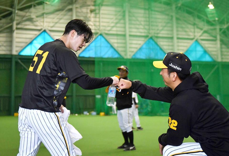 　秋季キャンプ初日に藤川監督（右）とタッチを交わす中野＝１日