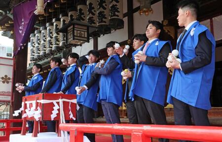 　初天神梅花祭に参加し、福玉を投げる（右から）福島、松原、津田、石黒、百崎、山田、椎葉、下村（撮影・立川洋一郎）