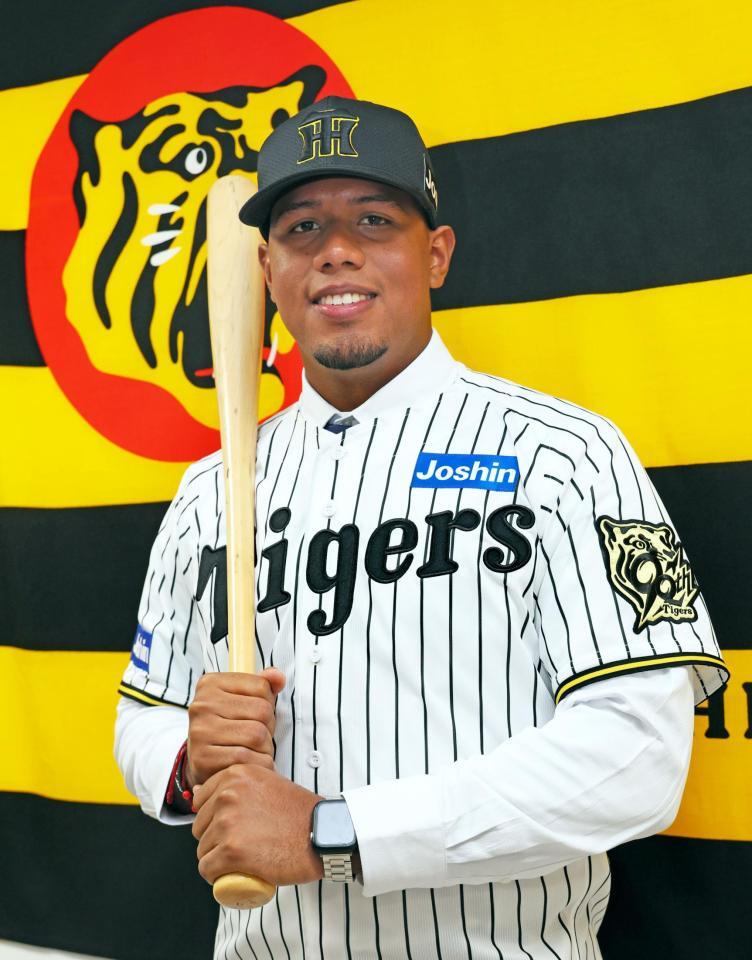 　入団会見を終えてユニホームに袖を通し、活躍を誓うアルナエス（撮影・立川洋一郎）