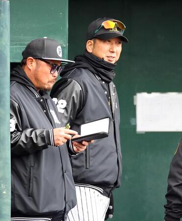 　紅白戦中、ベンチで小谷野コーチ（左）と話をする藤川監督