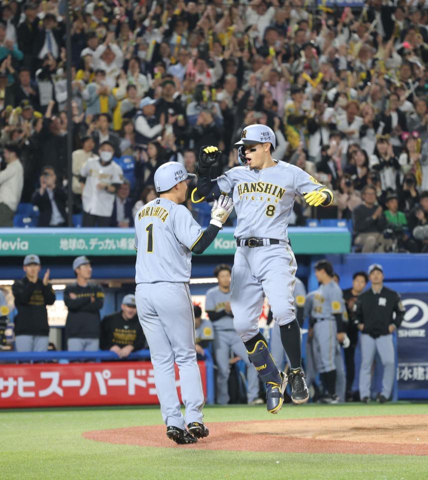 　８回、逆転２ランを放ち、森下（左）とハイタッチを交わす佐藤輝（撮影・西岡正）