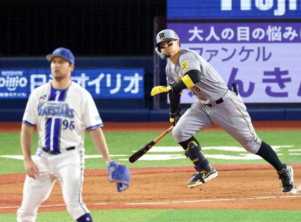 　４回、バウアー（左）から適時二塁打を放つ佐藤輝（撮影・金田祐二）