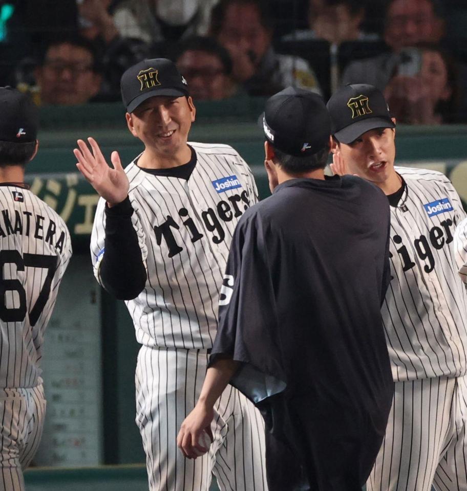 　今季４勝目を挙げた村上を迎える藤川監督（左）＝撮影・中田匡峻