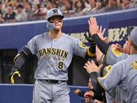 　４回、ライトへ同点ソロを放ち、ナインとタッチを交わす佐藤輝（撮影・中田匡峻）