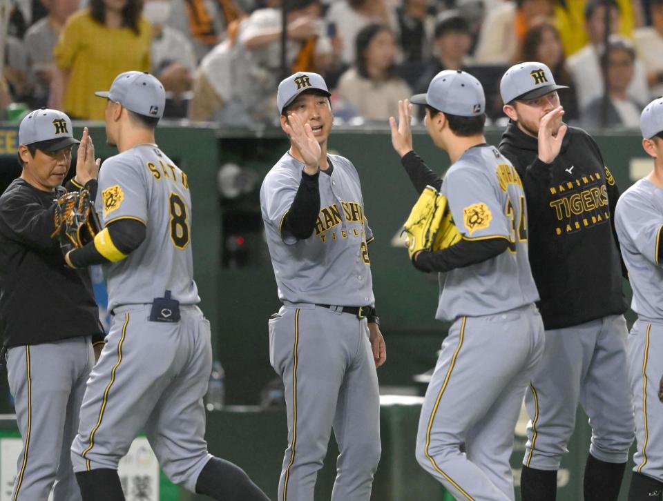 　試合後、漆原を迎える藤川監督（中央）。右端はビーズリー（撮影・堀内翔）